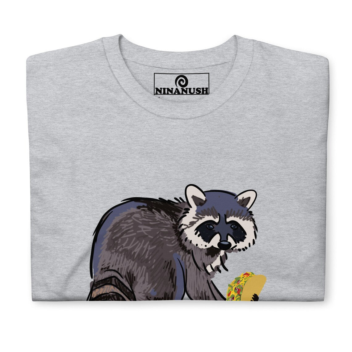 Gray funny raccoon shirt for taco lovers and foodies This funky raccoon and taco lover t-shirt is colorful, hand drawn and made just for you. It's a classic comfortable t-shirt with a totally unique design of a raccoon eating a taco. Eat tacos in style or give this shirt as a funny raccoon lover gift. Celebrate your favorite foods in our funny food shirts and accessories.
