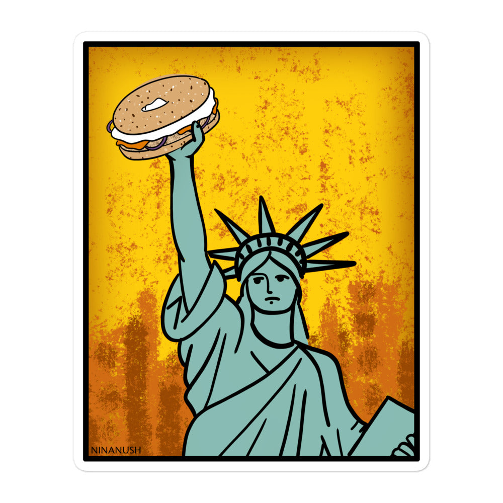 5.5 x 5.5 Statue of Liberty holding a bagel sticker from Nina's Funky Shop by ninanush - The New York Bagel Vinyl Sticker! Designed for bagel enthusiasts, this unique sticker has the Statue of Liberty holding a classic New York bagel. It's an original hand drawn design by Nina and it's made just for you. This funky bagel sticker is the perfect addition to your sticker collection or gift for a bagel lover.