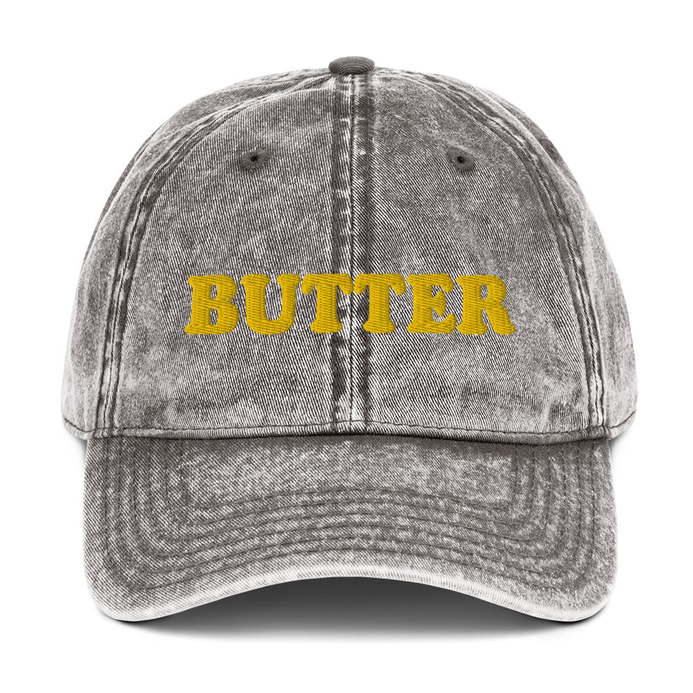 Gray Butter Dad Hat - Do you love butter? This butter hat is just what you need. It's comfortable, has an adjustable closure, and comes in a variety of colors with "butter", expertly embroidered on the front. Add a little personality to your everyday style with this funny foodie hat. Perfect for butter lovers and beyond. Celebrate your favorite foods in our funky foodie clothing and accessories.