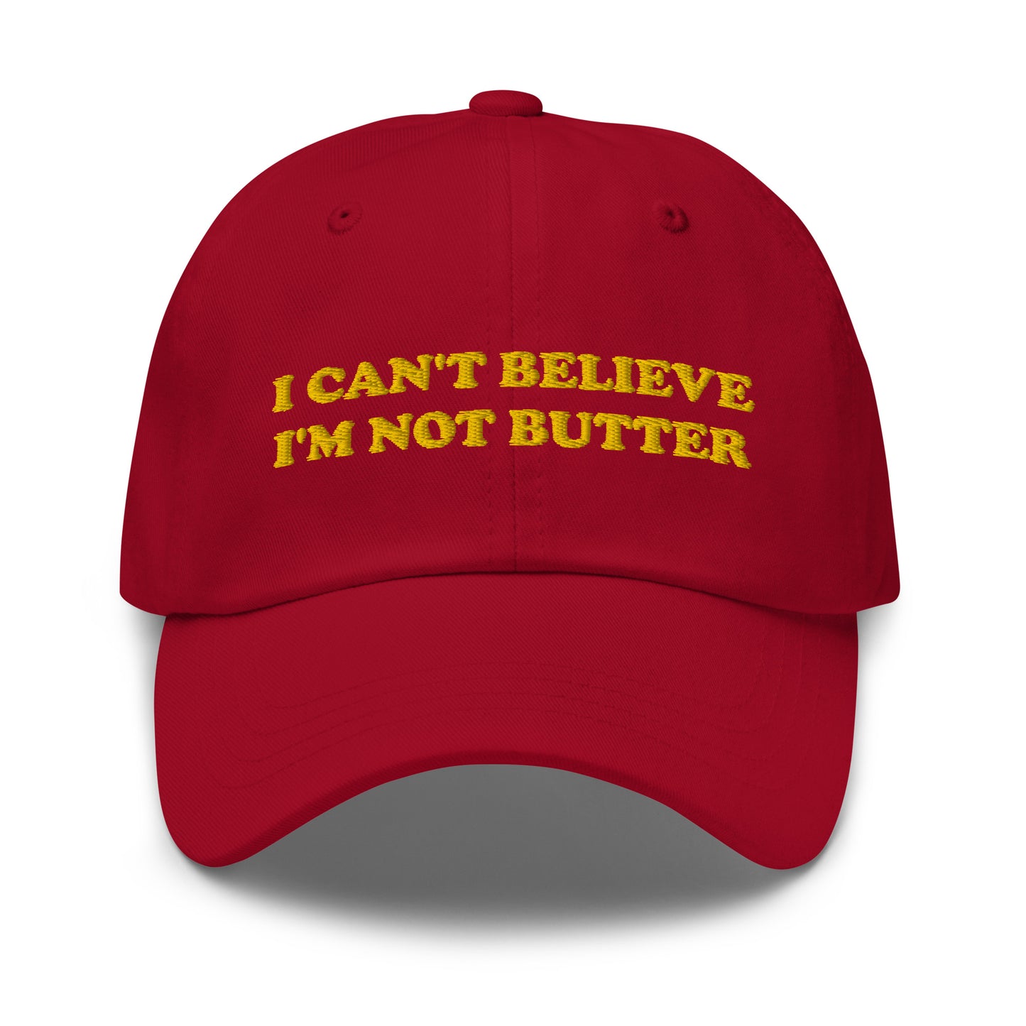 Red I Can't Believe I'm Not Butter Hat - Our I can't believe I'm not butter hat is comfortable, comes in a variety of colors and has an adjustable closure. It's a classic dad hat with a funny saying, expertly embroidered on the front. Perfect for everyday streetwear and sure to turn heads and have everyone asking, "Where'd you get that hat?"