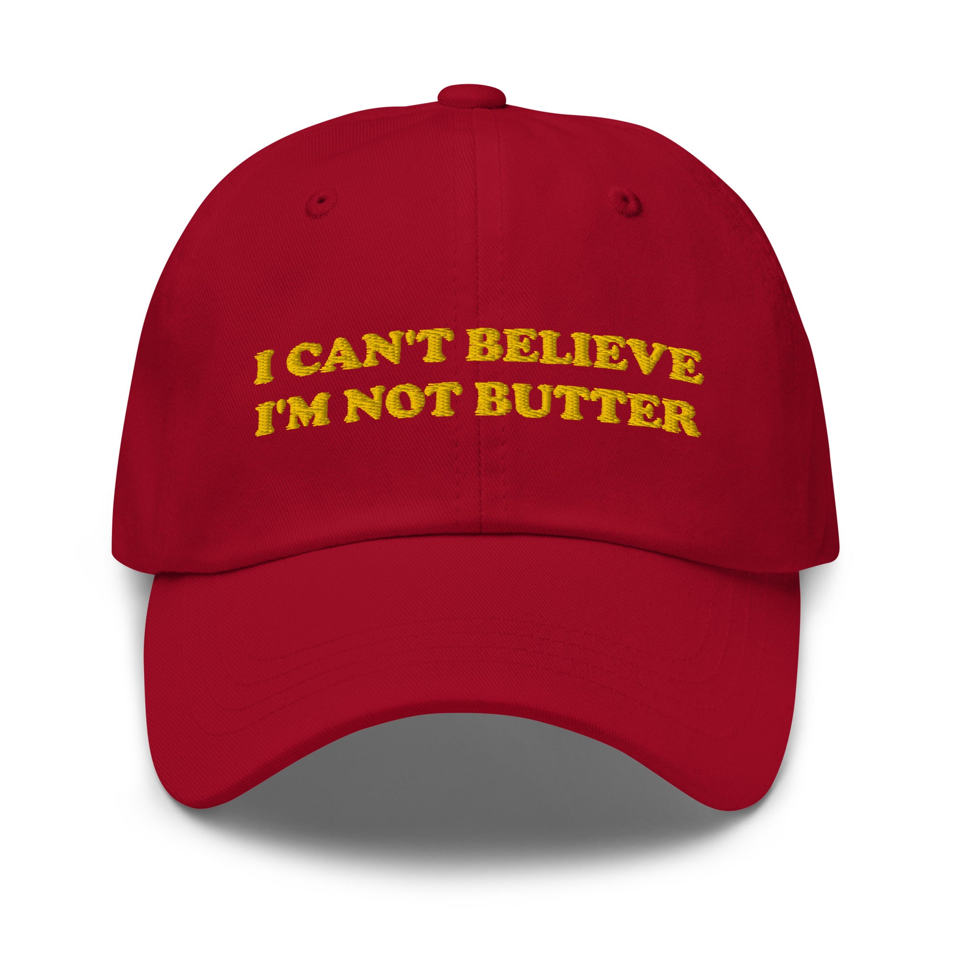 Red I Can't Believe I'm Not Butter Hat - Our I can't believe I'm not butter hat is comfortable, comes in a variety of colors and has an adjustable closure. It's a classic dad hat with a funny saying, expertly embroidered on the front. Perfect for everyday streetwear and sure to turn heads and have everyone asking, "Where'd you get that hat?"