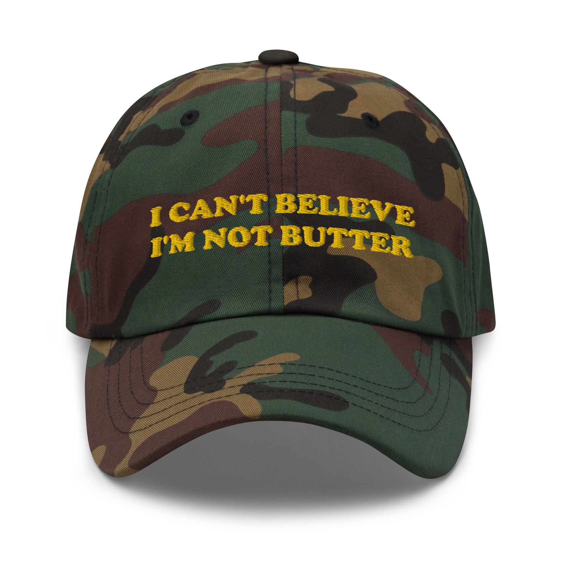 Camo I Can't Believe I'm Not Butter Hat - Our I can't believe I'm not butter hat is comfortable, comes in a variety of colors and has an adjustable closure. It's a classic dad hat with a funny saying, expertly embroidered on the front. Perfect for everyday streetwear and sure to turn heads and have everyone asking, "Where'd you get that hat?"