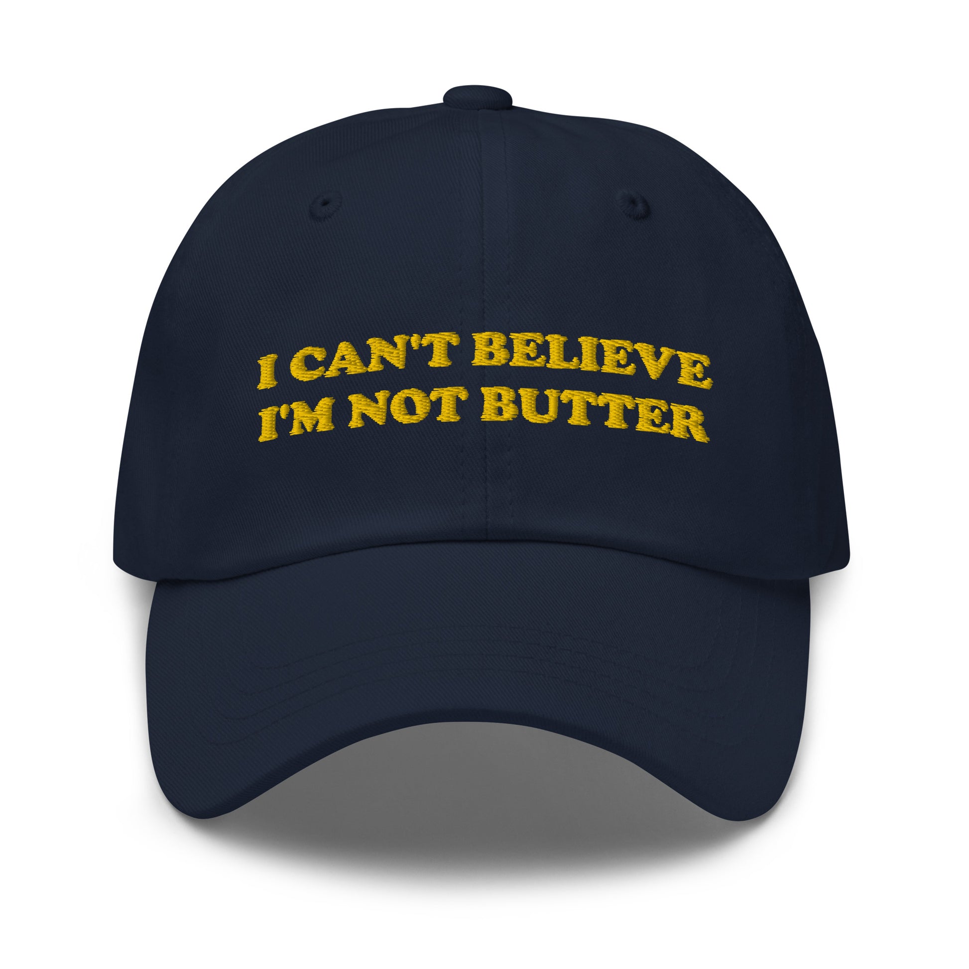 Navy I Can't Believe I'm Not Butter Hat - Our I can't believe I'm not butter hat is comfortable, comes in a variety of colors and has an adjustable closure. It's a classic dad hat with a funny saying, expertly embroidered on the front. Perfect for everyday streetwear and sure to turn heads and have everyone asking, "Where'd you get that hat?"