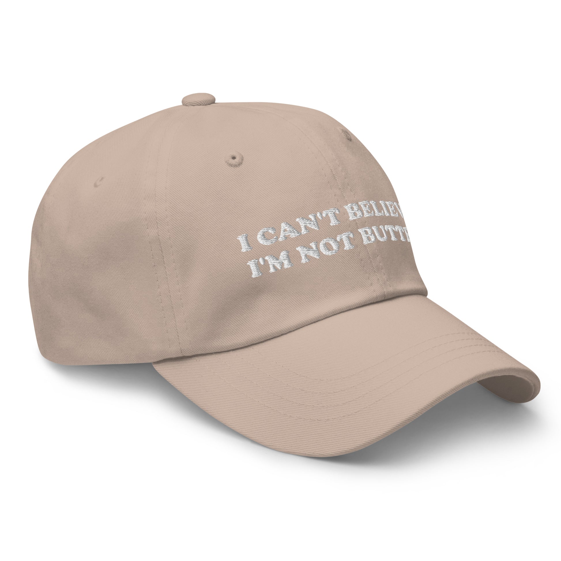 Stone I Can't Believe I'm Not Butter Hat - Our I can't believe I'm not butter hat is comfortable, comes in a variety of colors and has an adjustable closure. It's a classic dad hat with a funny saying, expertly embroidered on the front. Perfect for everyday streetwear and sure to turn heads and have everyone asking, "Where'd you get that hat?"