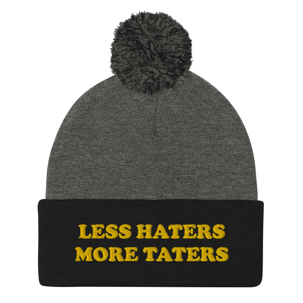 Black and Gray Less Haters More Taters Hat from Nina's Funky Shop - Lover potatoes? Looking for a funny gift? This warm and cozy, embroidered beanie is just what you need. It's a classic pom pom beanie with "less haters more taters", expertly embroidered on the front. The perfect funny beanie for potato enthusiasts and foodies of all kinds. Celebrate your favorite foods in our funky foodie apparel.
