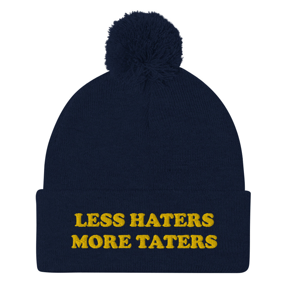 Navy Less Haters More Taters Hat from Nina's Funky Shop - Lover potatoes? Looking for a funny gift? This warm and cozy, embroidered beanie is just what you need. It's a classic pom pom beanie with "less haters more taters", expertly embroidered on the front. The perfect funny beanie for potato enthusiasts and foodies of all kinds. Celebrate your favorite foods in our funky foodie apparel.