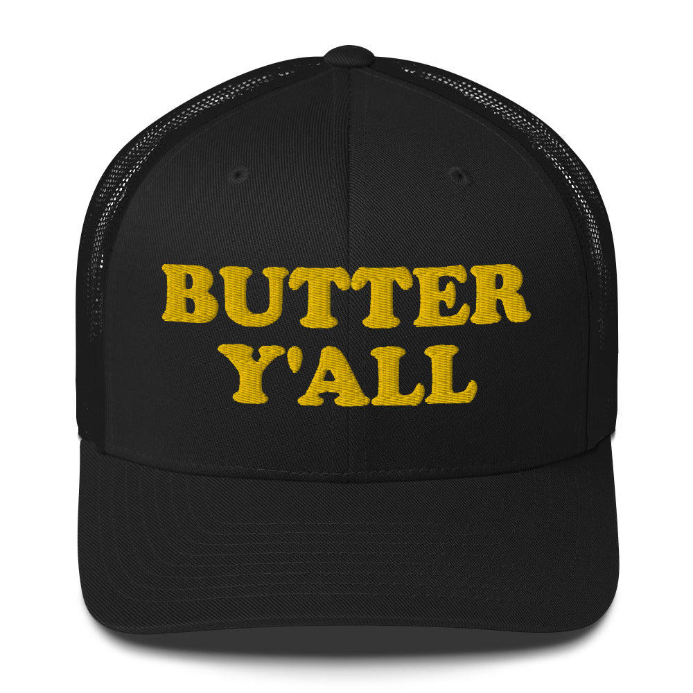 Black Butter Hat - Are you a butter enthusiast? Looking for a funny gift? Our Butter Y'all Hat is comfortable and made just for you. It comes in a variety of colors with a funny butter phrase, expertly embroidered on the front. Make a statement and eat your favorite buttery foods in our butter y'all trucker hat.  Edit alt text