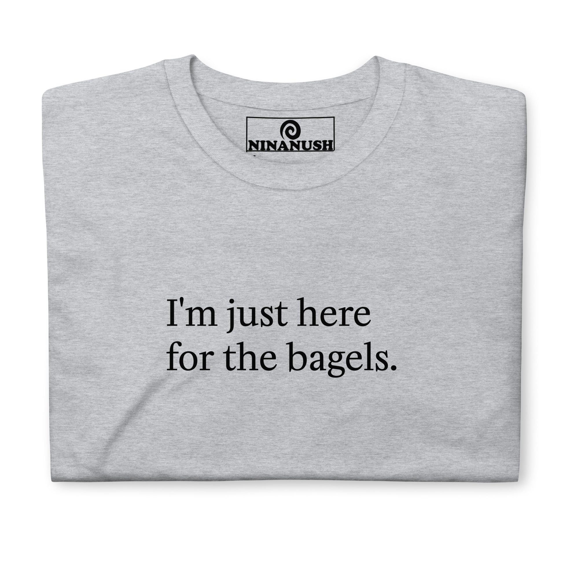 Gray bagel saying t-shirt - "I'm just here for the bagels." This bagel enthusiast t-shirt is a comfortable classic tee with a funny bagel quote on the front. Make a statement and eat bagels in this weird shirt for bagel lovers and foodies of all kinds. Great for everyday streetwear or a gift for your favorite bagel antisocial lover enthusiast. Celebrate your favorite foods in our funky foodie clothing and accessories. 