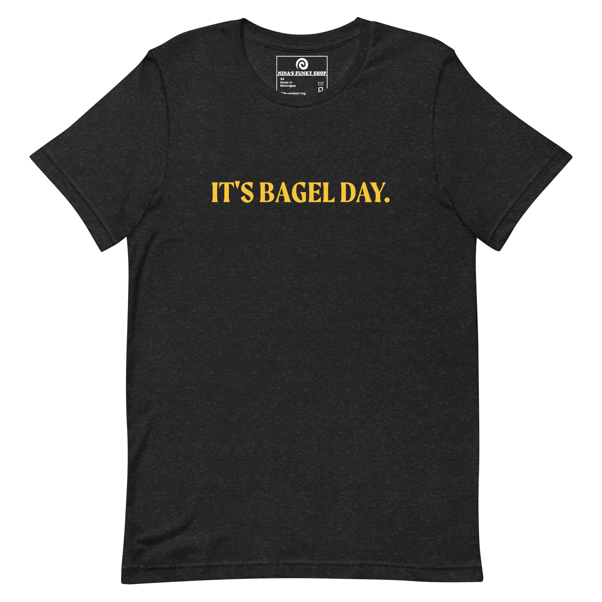 Black It's Bagel Day T-Shirt - Are you a bagel enthusiast? Looking for a funny gift for a fellow bagel lover? Every day is bagel day in our "It's Bagel Day T-shirt". It's a soft and comfortable, unisex t-shirt that comes in a variety of colors with a funny bagel saying, expertly printed on the front. Eat your favorite bagels and make a statement. Celebrate your favorite foods in our funky foodie apparel.