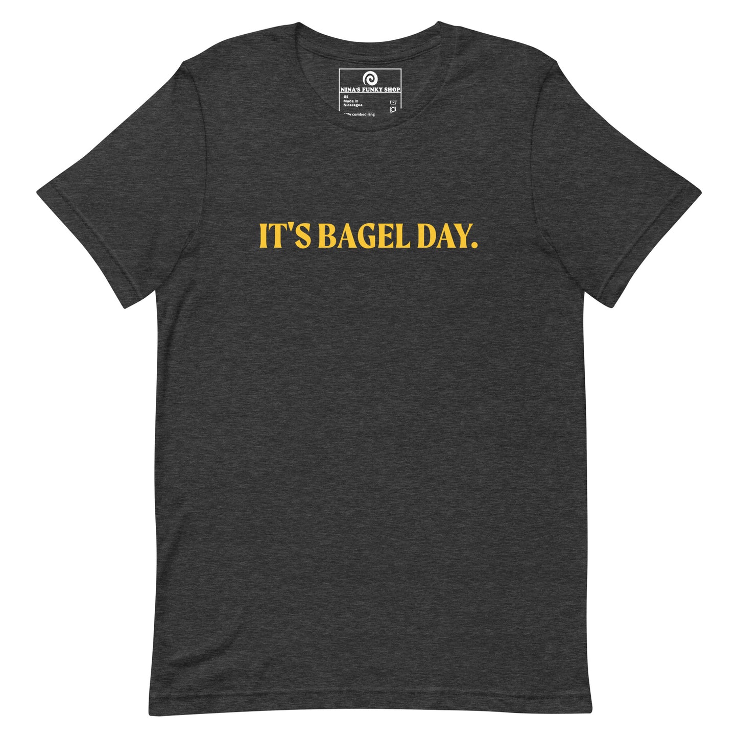 Dark Gray It's Bagel Day T-Shirt - Are you a bagel enthusiast? Looking for a funny gift for a fellow bagel lover? Every day is bagel day in our "It's Bagel Day T-shirt". It's a soft and comfortable, unisex t-shirt that comes in a variety of colors with a funny bagel saying, expertly printed on the front. Eat your favorite bagels and make a statement. Celebrate your favorite foods in our funky foodie apparel. 