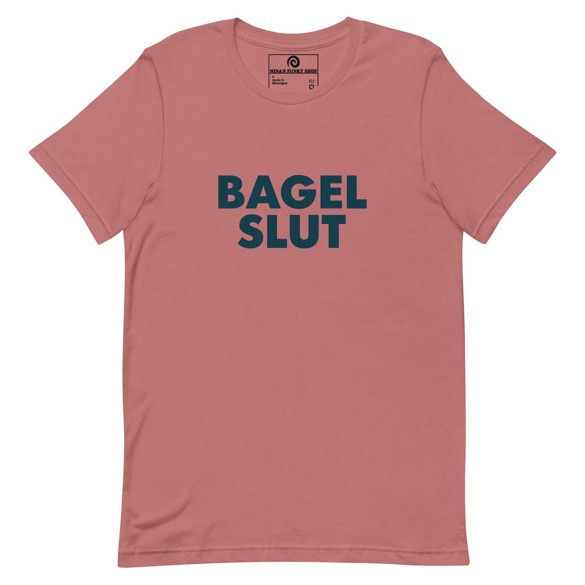 Mauve Bagel Slut T-Shirt - Our Bagel Slut T-shirt is soft, comfortable and just what you need. It's a unisex t-shirt that comes in a variety of colors with a funny foodie design, expertly printed on the front. Stand out in our sarcastic t-shirts and celebrate your favorite foods in our funky foodie apparel. Designed by Nina and made just for you! Looking for something personalized? Shoot us an email!