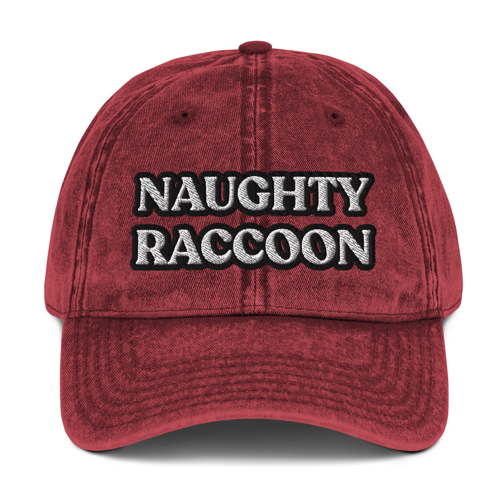 Maroon naughty raccoon dad hat from Nina's Funky Shop by ninanush - Stand out in this naughty raccoon hat. It's a vintage style embroidered dad hat with the words "naughty raccoon" in black and white on the front. This unique hat for raccoon enthusiasts is funny and just a little weird. Add a little personality to your everyday style or give it as a funny gift for a raccoon lover.