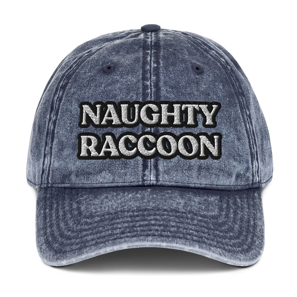 Blue naughty raccoon dad hat from Nina's Funky Shop by ninanush - Stand out in this naughty raccoon hat. It's a vintage style embroidered dad hat with the words "naughty raccoon" in black and white on the front. This unique hat for raccoon enthusiasts is funny and just a little weird. Add a little personality to your everyday style or give it as a funny gift for a raccoon lover.