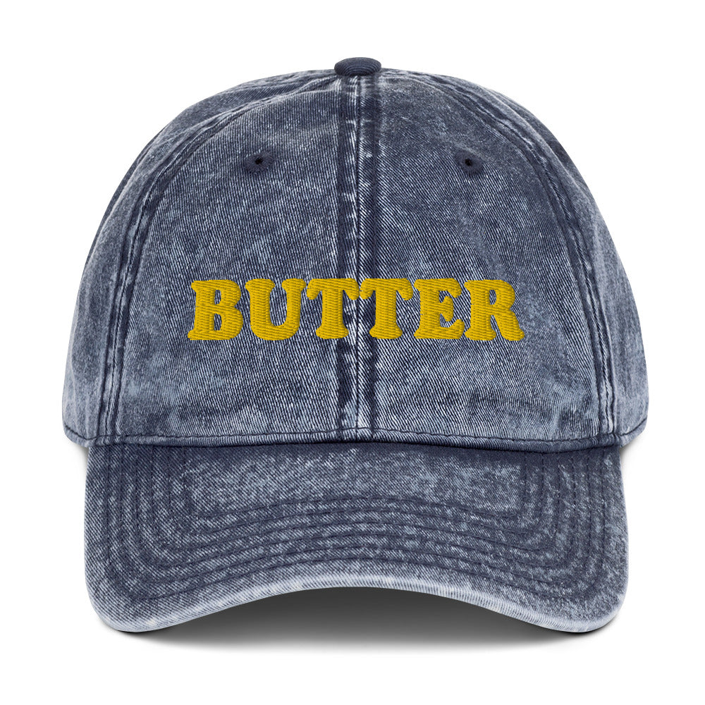 Navy Butter Dad Hat - Do you love butter? This butter hat is just what you need. It's comfortable, has an adjustable closure, and comes in a variety of colors with "butter", expertly embroidered on the front. Add a little personality to your everyday style with this funny foodie hat. Perfect for butter lovers and beyond. Celebrate your favorite foods in our funky foodie clothing and accessories.