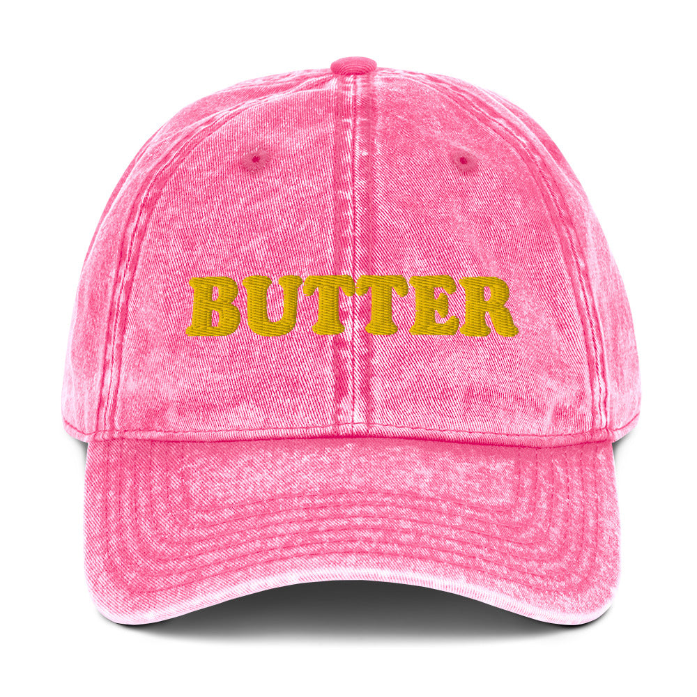 Pink Butter Dad Hat - Do you love butter? This butter hat is just what you need. It's comfortable, has an adjustable closure, and comes in a variety of colors with "butter", expertly embroidered on the front. Add a little personality to your everyday style with this funny foodie hat. Perfect for butter lovers and beyond. Celebrate your favorite foods in our funky foodie clothing and accessories.