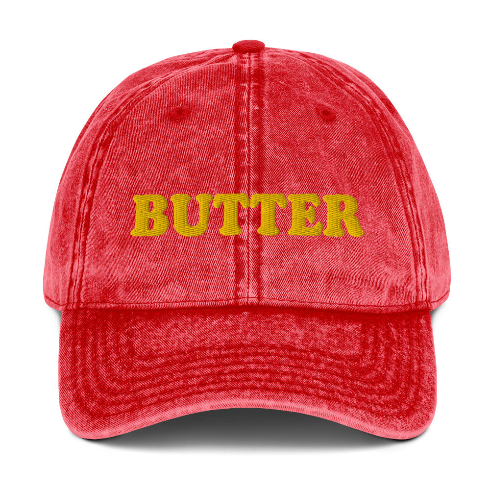 Red Butter Dad Hat - Do you love butter? This butter hat is just what you need. It's comfortable, has an adjustable closure, and comes in a variety of colors with "butter", expertly embroidered on the front. Add a little personality to your everyday style with this funny foodie hat. Perfect for butter lovers and beyond. Celebrate your favorite foods in our funky foodie clothing and accessories.
