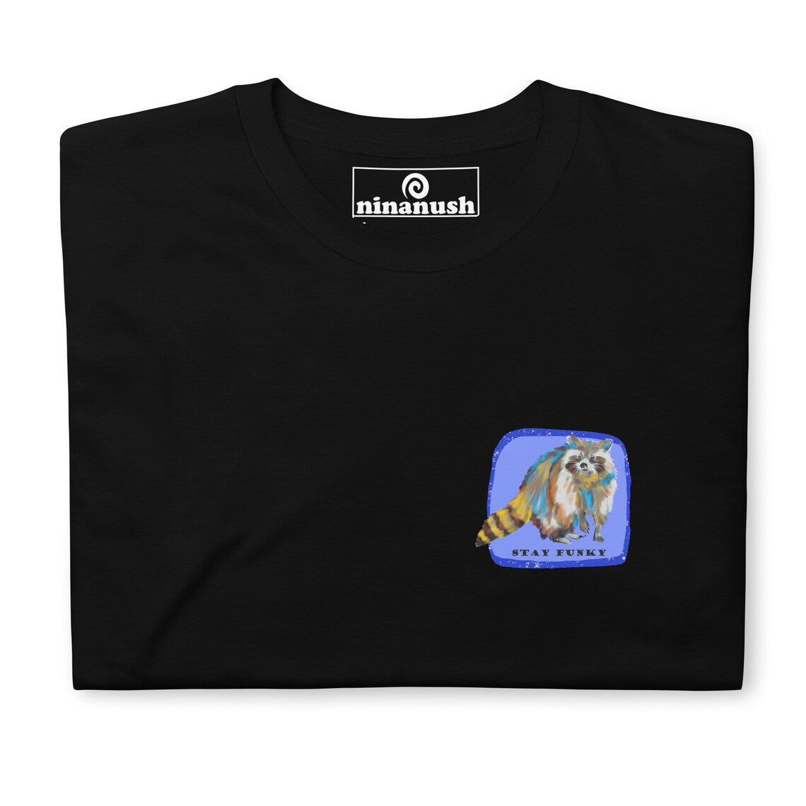 "Stay Funky" t-shirt with a colorful, hand drawn raccoon. This unique raccoon t-shirt is funky and original with a large raccoon print on the back. The multicolor raccoon tshirt is a funky shirt for animal lovers. Shop more weird raccoon shirts, funny vegan foodie hats, funky and unique graphic t-shirts, hoodies and more. 